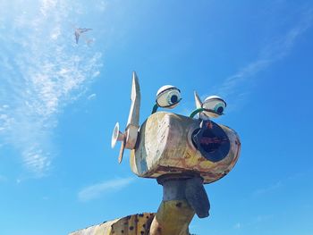 Low angle view of sculpture against blue sky