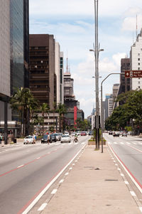 City street and buildings against sky