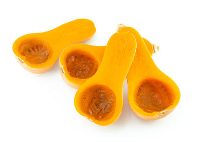 Close-up of orange fruit against white background