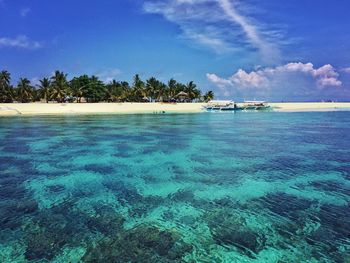 Scenic view of sea against blue sky