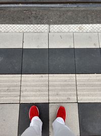 Low section of man standing on footpath