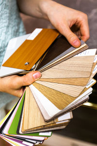 Cropped hand of woman holding book