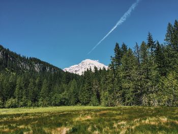 Scenic view of mountains against blue sky