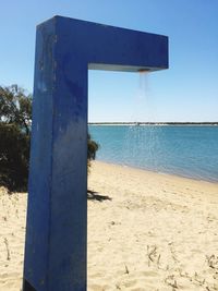 Scenic view of beach against clear blue sky