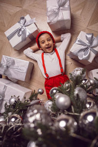 High angle view of girl playing with christmas decorations