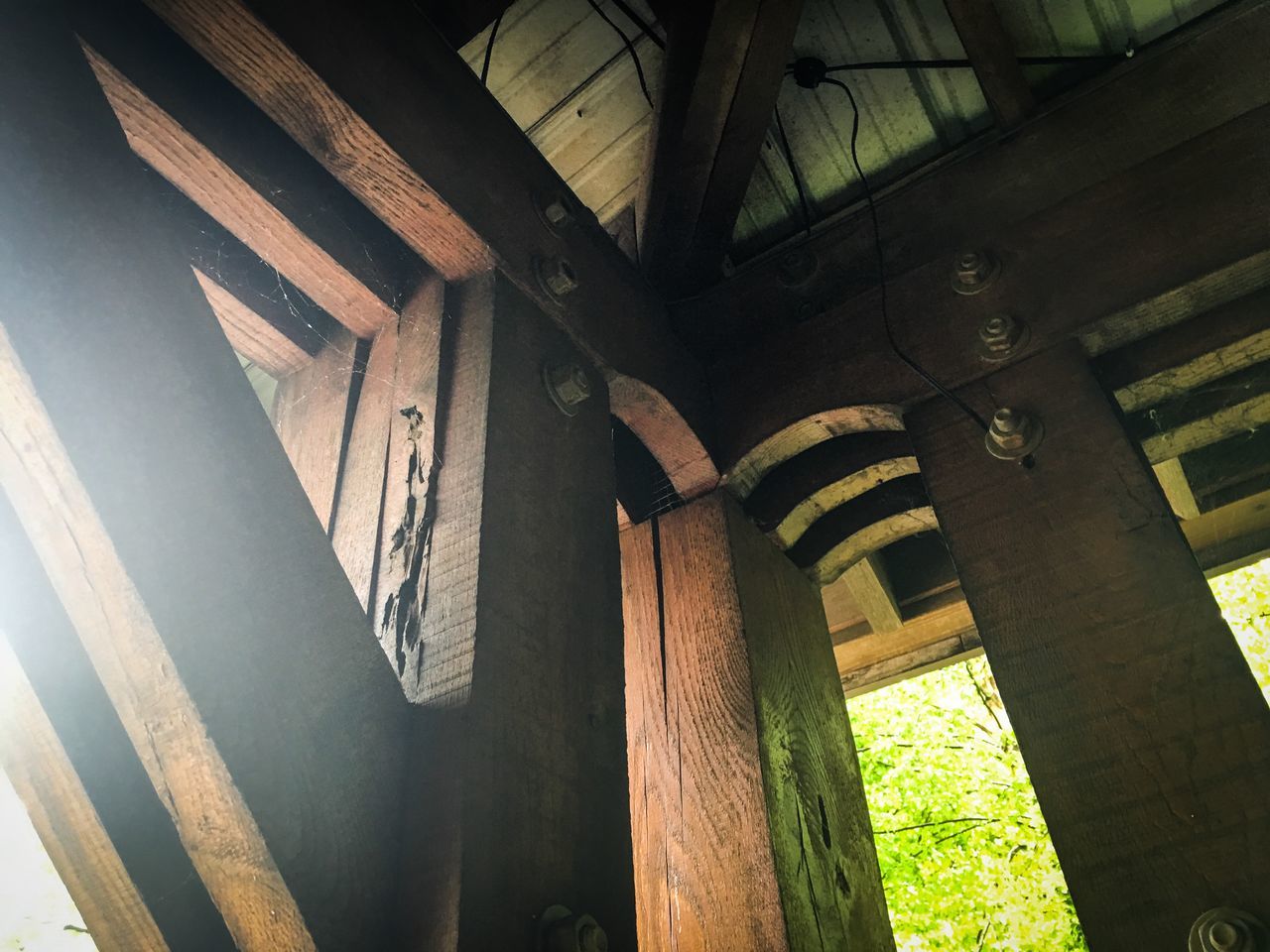 built structure, architecture, architectural column, indoors, column, low angle view, sunlight, building exterior, old, wood - material, building, no people, railing, shadow, day, window, door, abandoned, steps, staircase