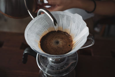 Barista dripping coffee and slow coffee wooden bar style