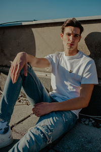 Portrait of young man sitting outdoors