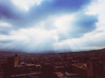 Buildings against cloudy sky
