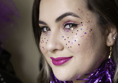 Close-up portrait of woman with confetti on face