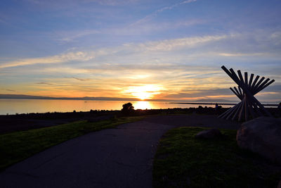 Scenic view of silhouette road against sky during sunset