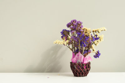 Close-up of flower vase on table against white background