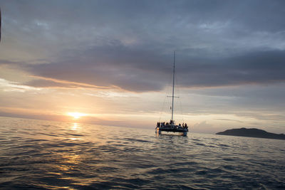 Boat sailing in sea during sunset