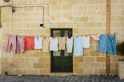 Clothes drying against brick wall