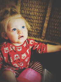 Portrait of cute girl sitting at home