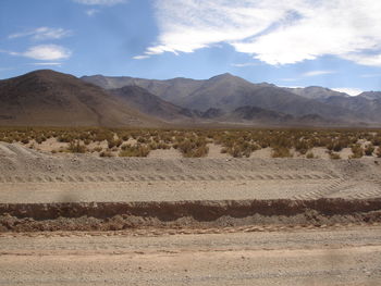 Scenic view of mountains against cloudy sky