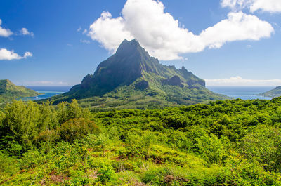 Scenic view of mountains against cloudy sky