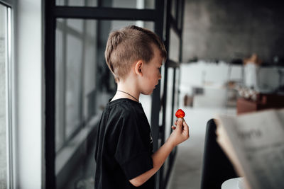 Portrait of boy looking through camera