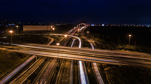 High angle view of light trails on highway at night