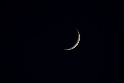 Low angle view of half moon against sky at night