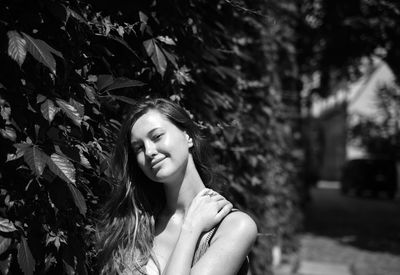 Portrait of beautiful young woman lying on land