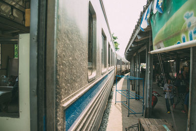 Train on railroad tracks amidst buildings in city