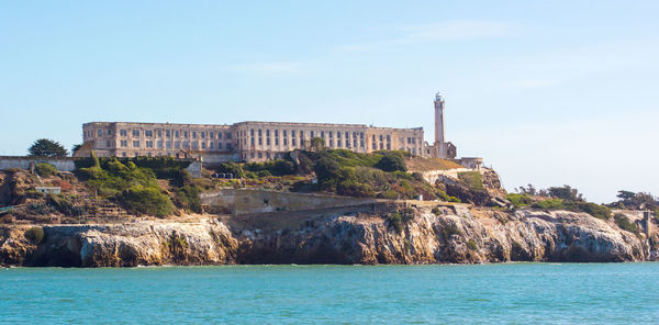 View of building by sea against sky