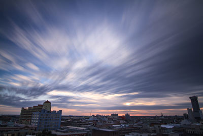 View of cityscape against cloudy sky