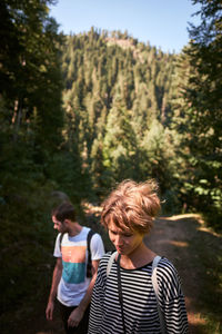 Man and woman in forest during sunny day