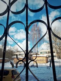 Close-up of snow covered cityscape against sky
