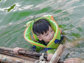 Cute boy swimming in lake