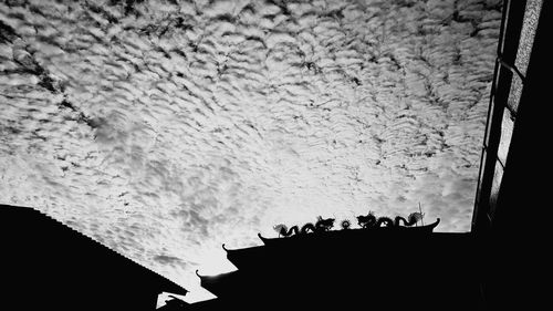 Silhouette of building against sky during winter