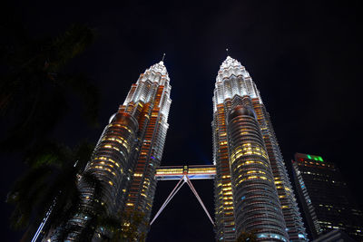 Low angle view of illuminated buildings against sky at night