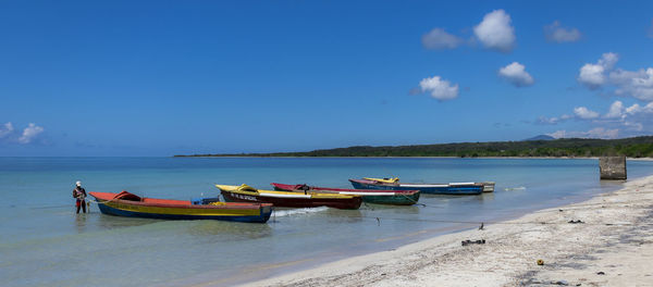 Boats moored on sea against sky