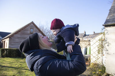 Side view of woman using mobile phone