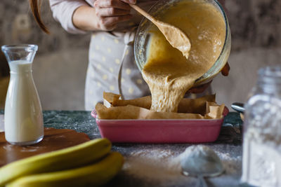 Midsection of woman baking at home