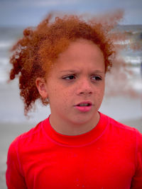 Curly redheaded boy at the beach