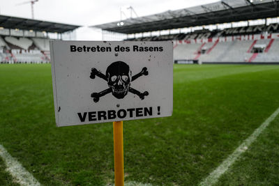 Close-up of warning sign on field