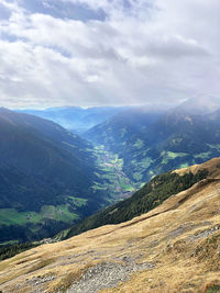 Scenic view of valley and mountains against sky