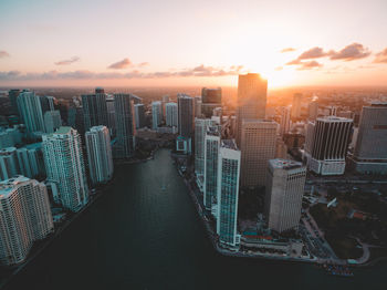 Aerial view of modern buildings against sky during sunset