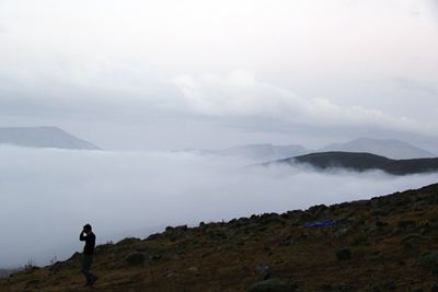 Woman looking at mountain landscape