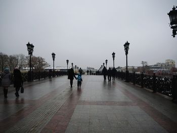 People walking on street in rain