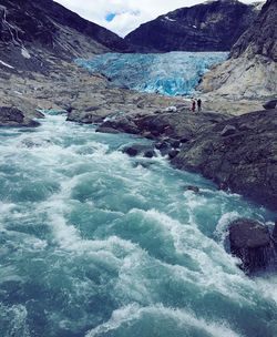 Scenic view of river flowing through rocks