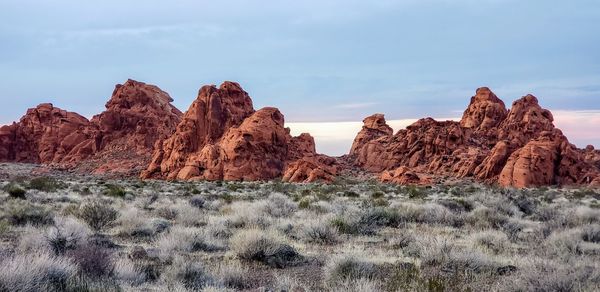 Rock formations on landscape against sky