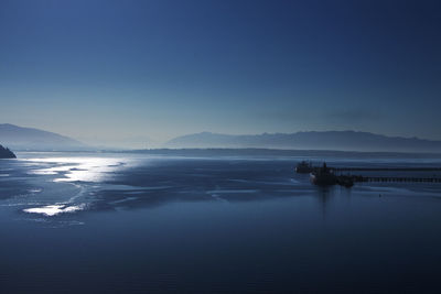 Scenic view of sea against clear blue sky