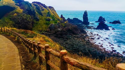 Scenic view of sea and mountains against sky