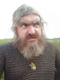 Close-up portrait of man standing against wall