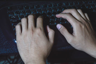 Cropped hands using laptop