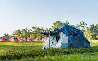 Tent in field against clear sky