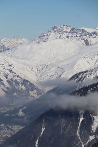 Scenic view of snowcapped mountains against clear sky